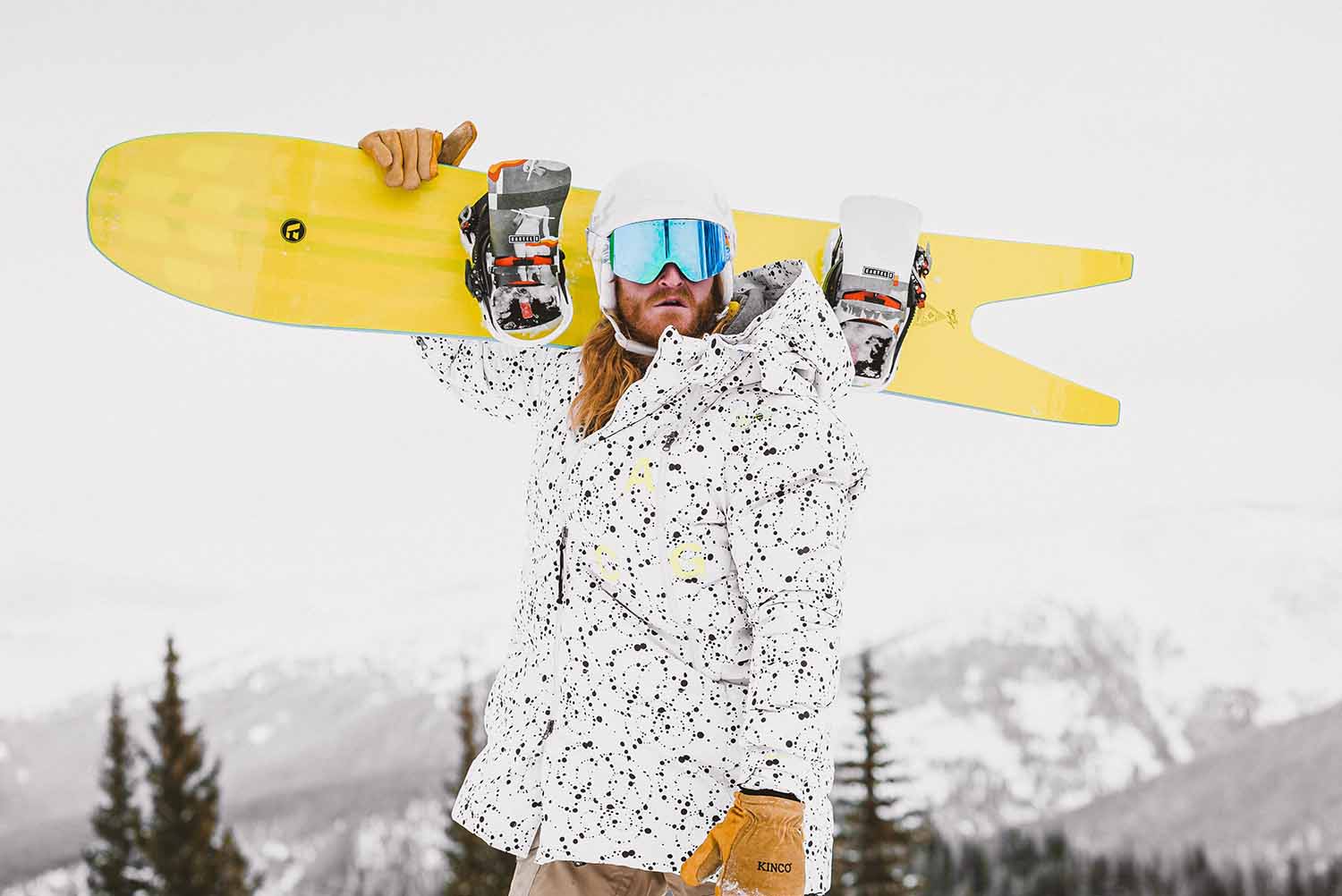 a person holding a yellow snowboard